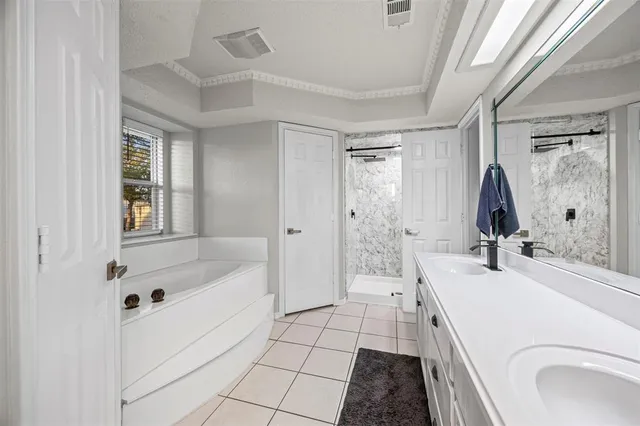 a bathroom with a sink a mirror a bathtub and shower
