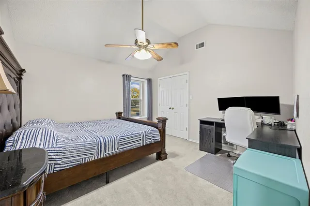 a bedroom with bed and a chandelier