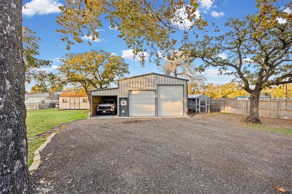 112 Saddle Hills Road Burleson, TX 76028 - Photo 30 of 38 a front view of a house with garden and trees
