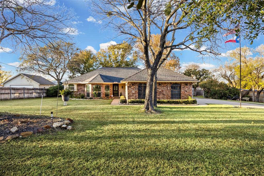 112 Saddle Hills Road Burleson, TX 76028 - Photo 5 of 38 a front view of a house with a yard table and chairs