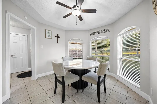 a dining room with furniture and window