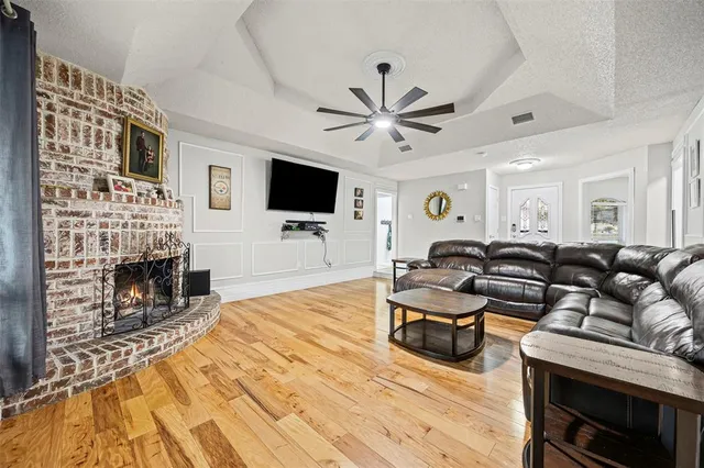 a living room with fireplace furniture and a flat screen tv
