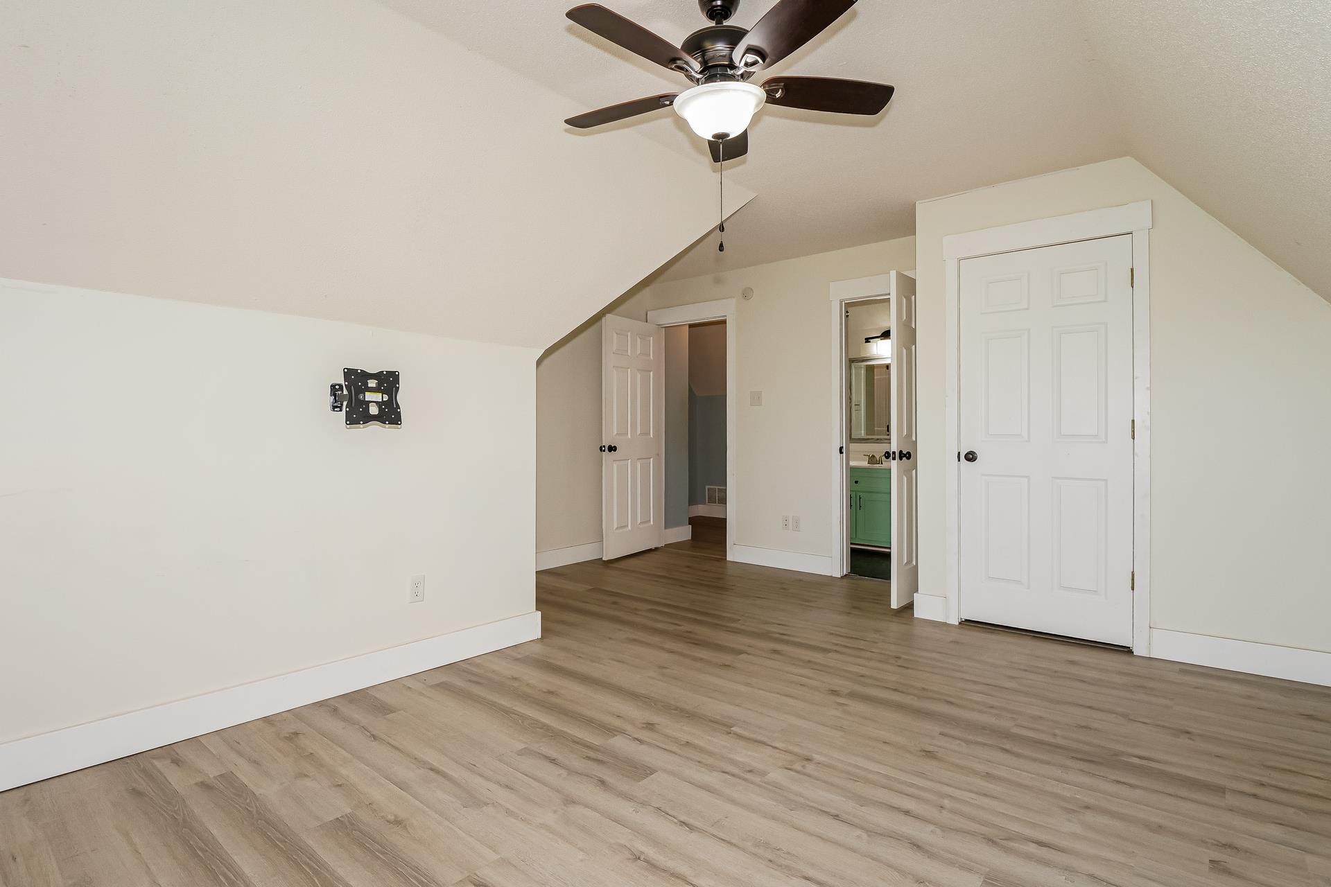 188 David Reed Drive Munford, TN 38058 - Photo 16 of 20 Spacious room with wood-finish flooring, a ceiling fan with integrated lighting, and sloped ceilings