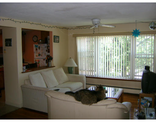 150 Main Street, Unit 9 Stoneham, MA 02180 - Photo 4 of 11 a living room with furniture and a flat screen tv