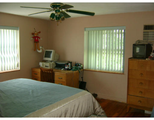 150 Main Street, Unit 9 Stoneham, MA 02180 - Photo 5 of 11 a bedroom with a bed and wooden floor