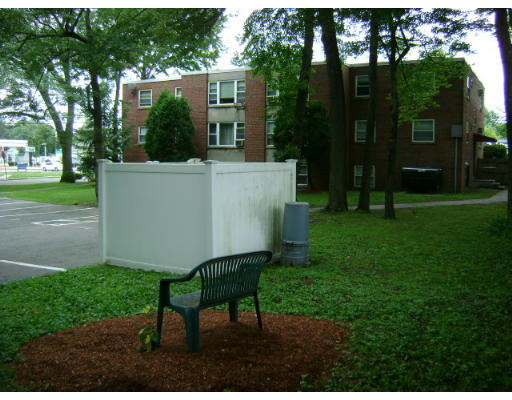 150 Main Street, Unit 9 Stoneham, MA 02180 - Photo 7 of 11 a view of a patio with table and chairs potted plants and large tree