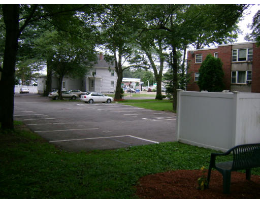 150 Main Street, Unit 9 Stoneham, MA 02180 - Photo 8 of 11 a view of a patio with table and chairs and a large tree