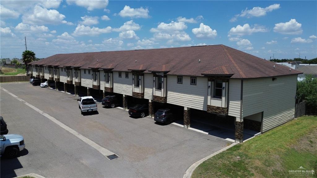 1500 Humming Bird Court, Unit 9 Pharr, TX 78577 - Photo 21 of 26 a front view of a house with yard and garage