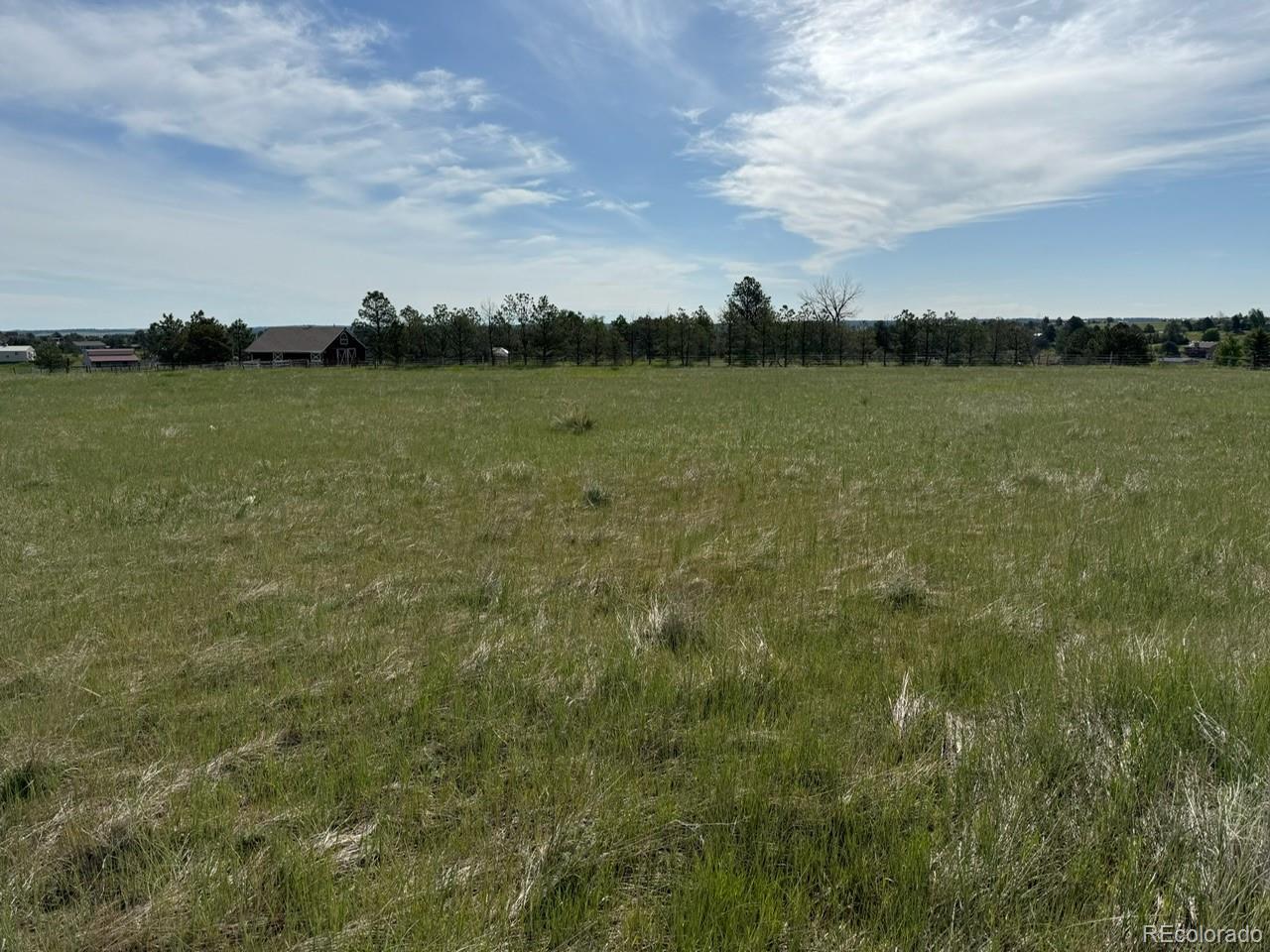 35501 Cheyenne Trail Elizabeth, CO 80107 - Photo 8 of 17 a view of a lake with houses in the back