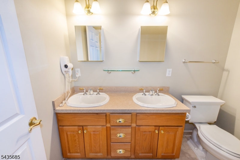 16 Main Street Sparta, NJ 07871 - Photo 17 of 33 a bathroom with a toilet sink and mirror
