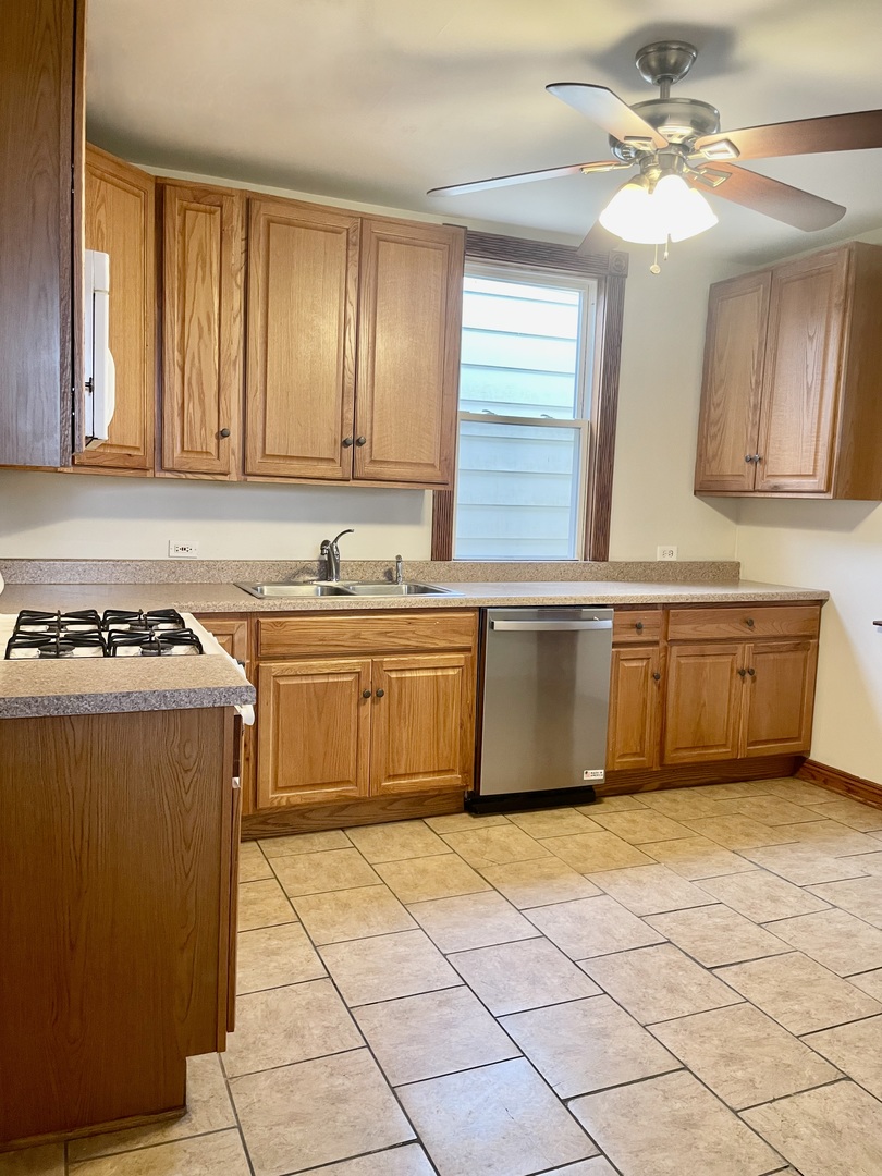 Undisclosed Address Chicago, IL 60618 - Photo 12 of 14 a kitchen with stainless steel appliances granite countertop a stove a sink and a refrigerator