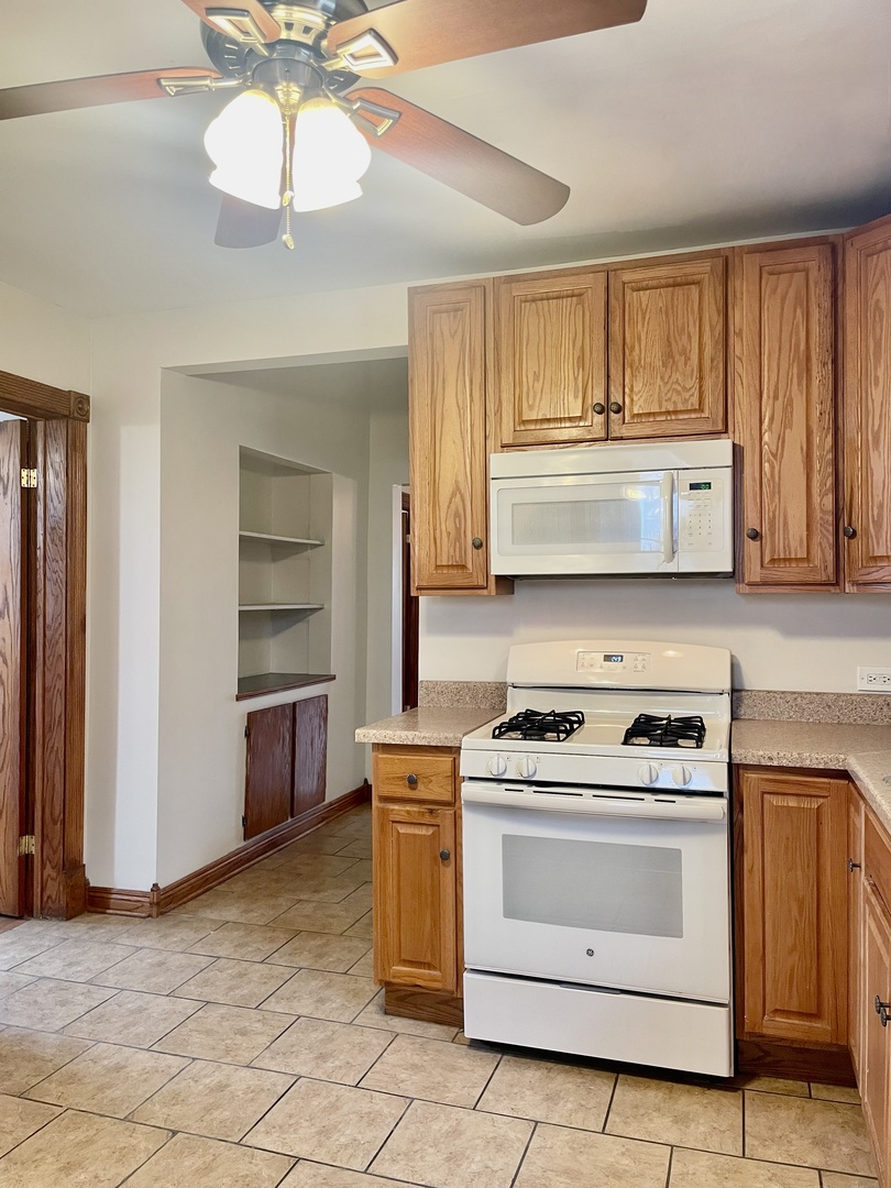 Undisclosed Address Chicago, IL 60618 - Photo 13 of 14 a kitchen with a stove oven and cabinets