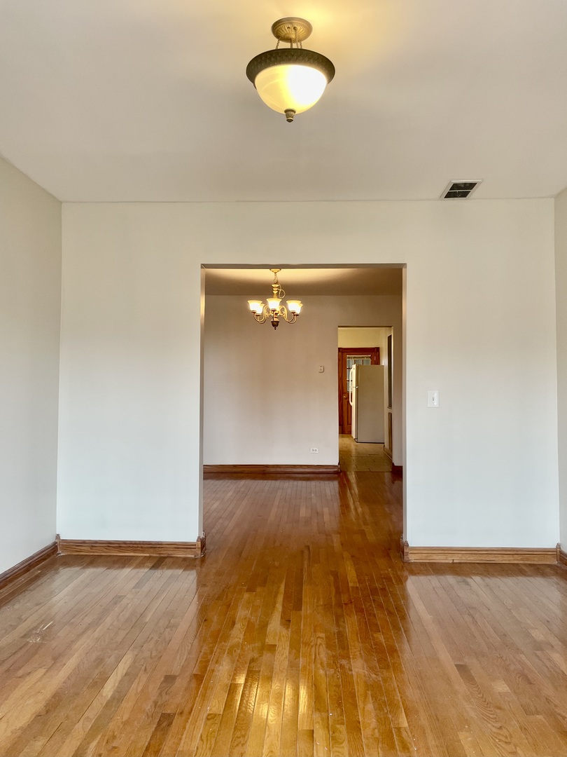 Undisclosed Address Chicago, IL 60618 - Photo 5 of 14 a view of empty room with wooden floor