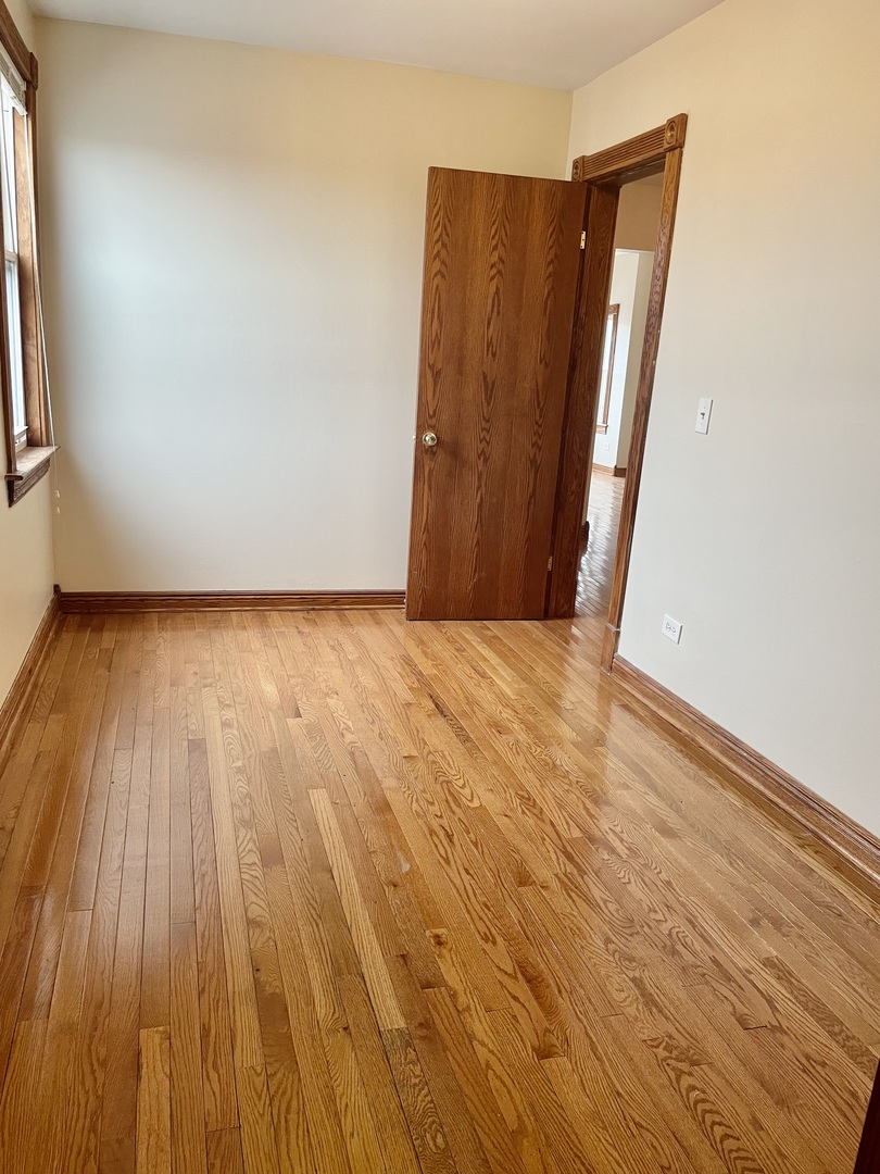 Undisclosed Address Chicago, IL 60618 - Photo 7 of 14 a view of a room with wooden floor and a window