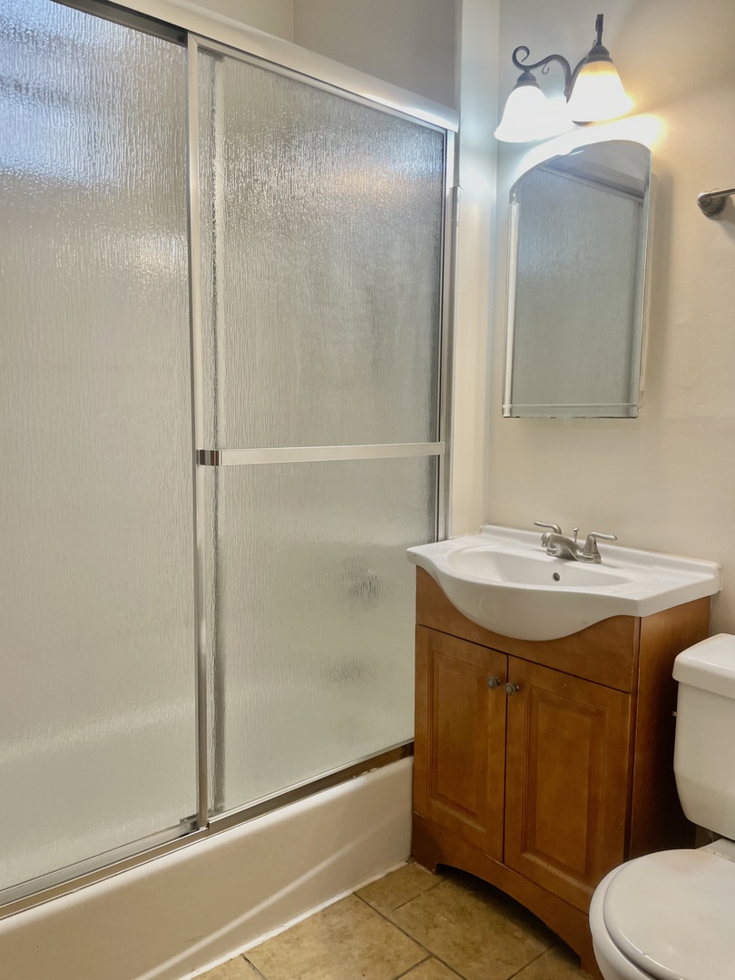 Undisclosed Address Chicago, IL 60618 - Photo 9 of 14 a bathroom with a granite countertop sink toilet and shower