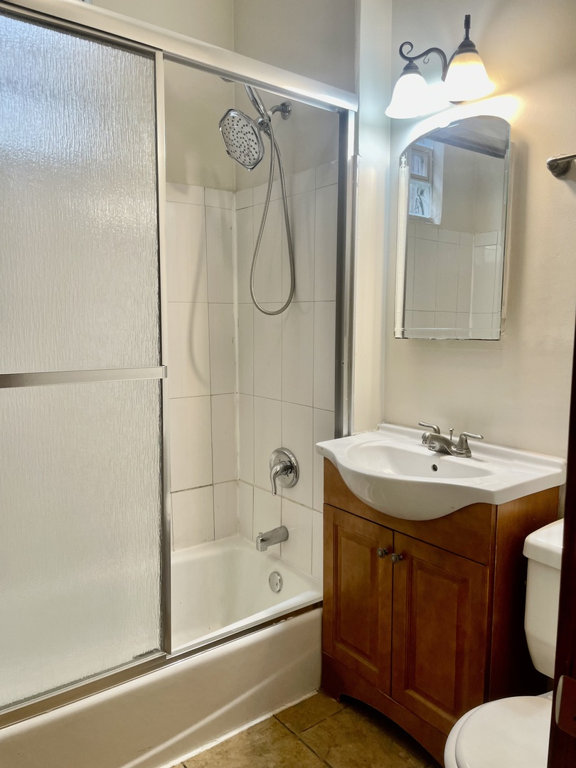 Undisclosed Address Chicago, IL 60618 - Photo 10 of 14 a bathroom with a granite countertop sink a toilet and shower