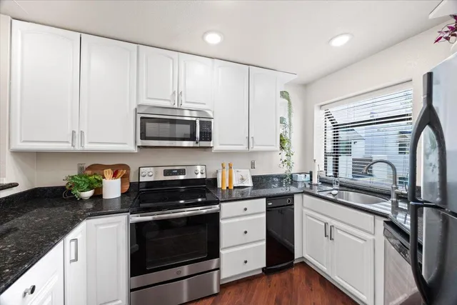 a kitchen with stainless steel appliances a refrigerator sink and cabinets