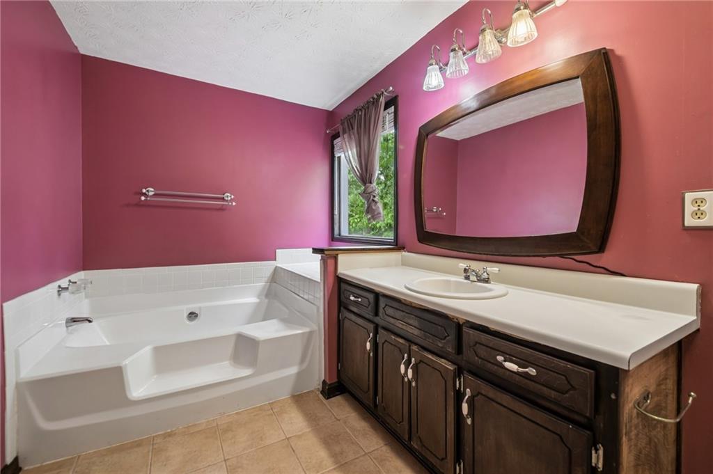 1318 Panhandle Way Hampton, GA 30228 - Photo 10 of 22 a bathroom with a sink vanity and a mirror
