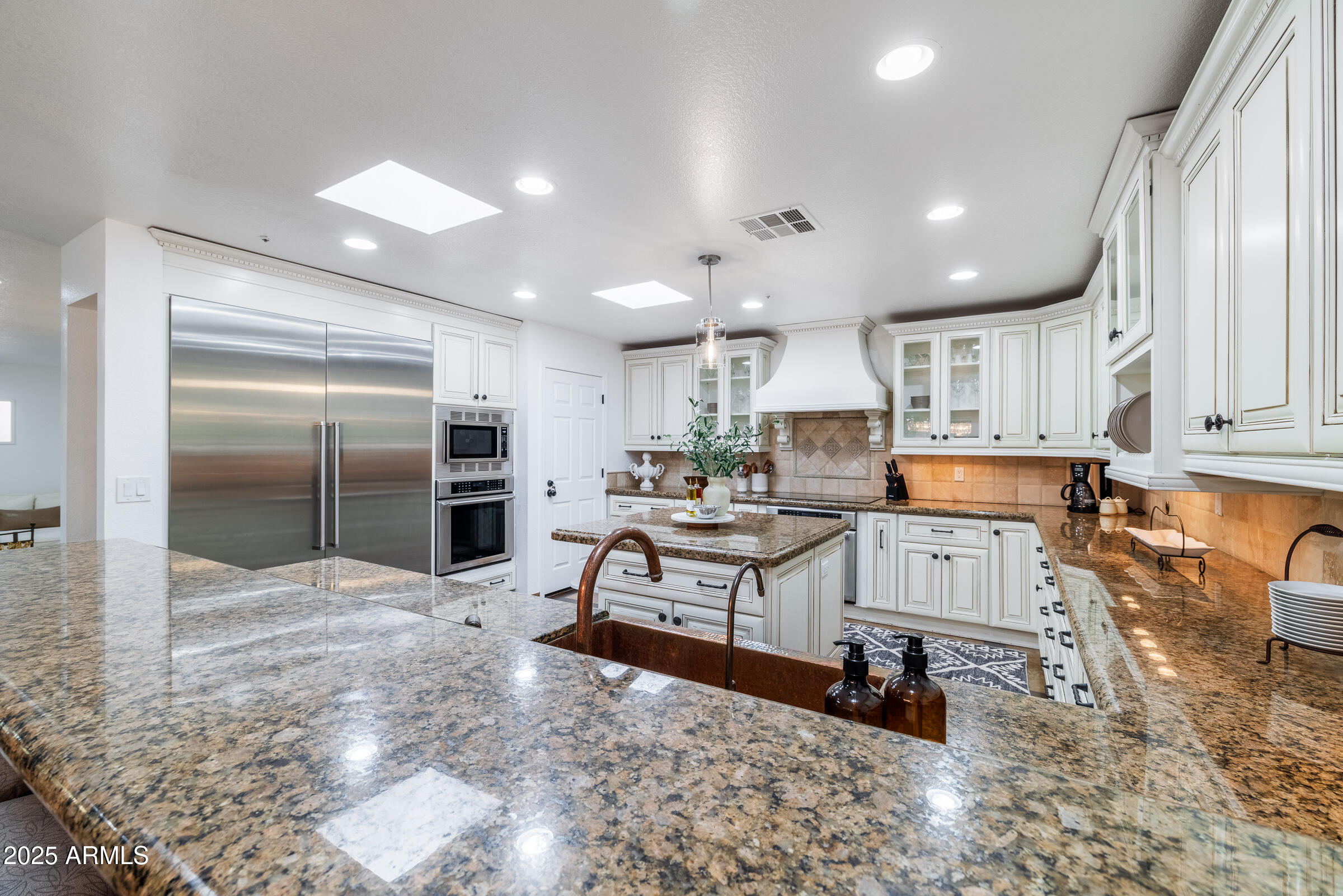 6835 East Peak View Road Scottsdale, AZ 85266 - Photo 7 of 107 a kitchen with stainless steel appliances kitchen island granite countertop a refrigerator and a sink