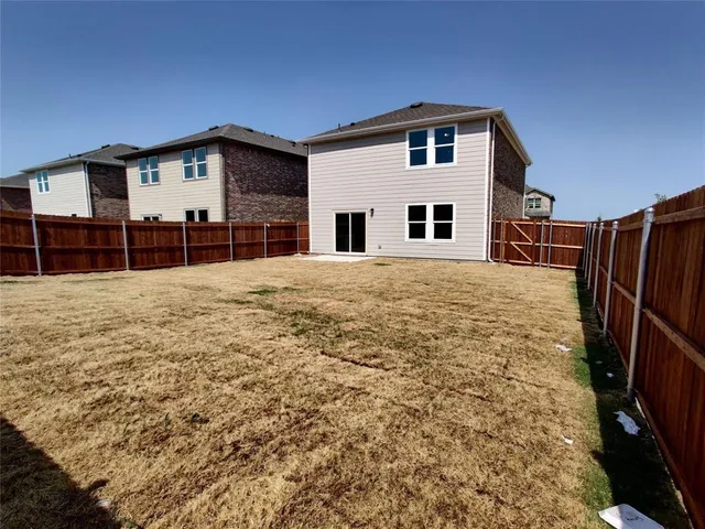 a view of a bedroom with wooden floor and a ceiling fan