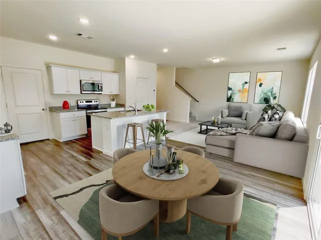 a living room with furniture and kitchen view