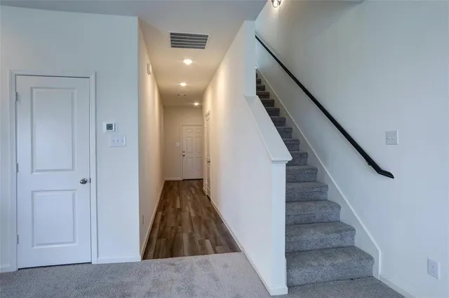 a view of a kitchen with wooden floor and electronic appliances