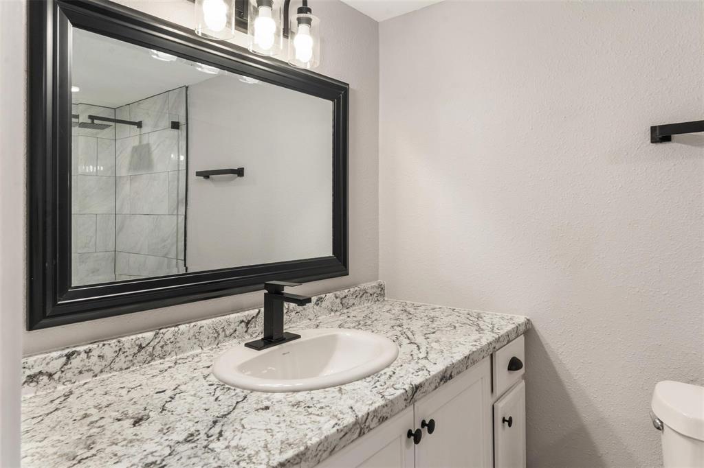 19930 Leisure Land Road Payne Springs, TX 75156 - Photo 14 of 21 a bathroom with a granite countertop sink and a mirror