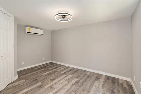 a view of a room with wooden floor