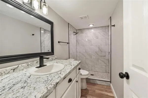 a bathroom with a sink double vanity shower and a mirror