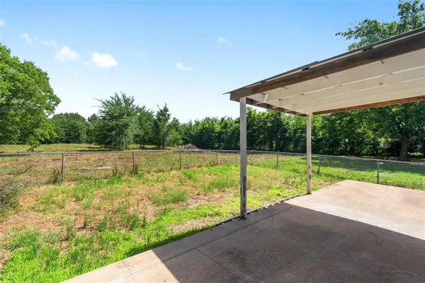 a view of a backyard with swimming pool