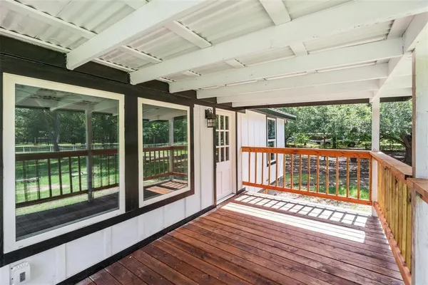 a view of a porch with wooden floor