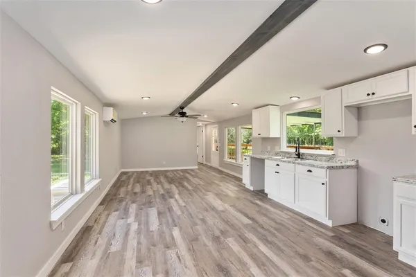 a large kitchen with a lot of counter space and a wooden floors