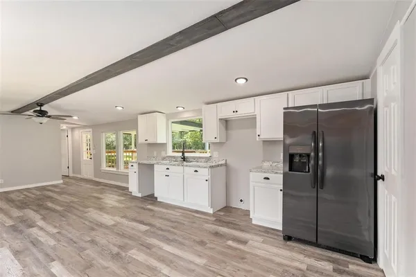 a large kitchen with a refrigerator a sink dishwasher a refrigerator and cabinets