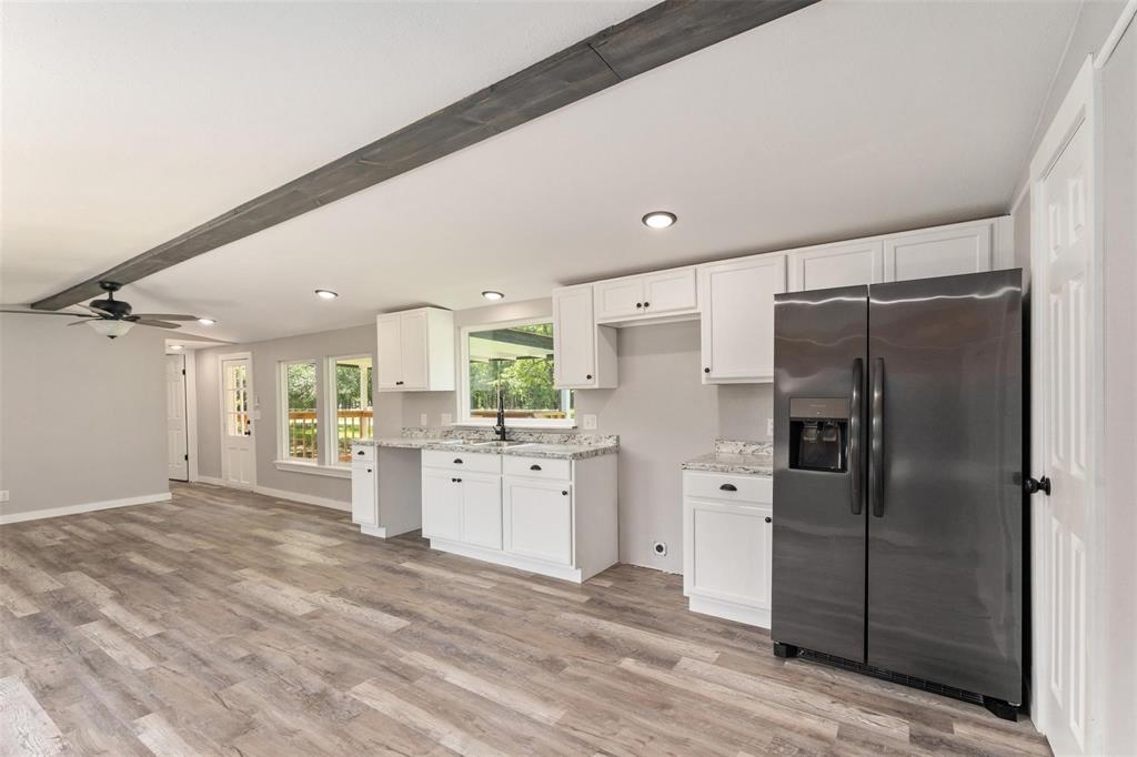 19930 Leisure Land Road Payne Springs, TX 75156 - Photo 10 of 21 a large kitchen with a refrigerator a sink dishwasher a refrigerator and cabinets