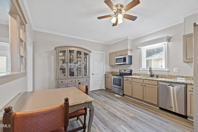 a kitchen with a table chairs stove and cabinets