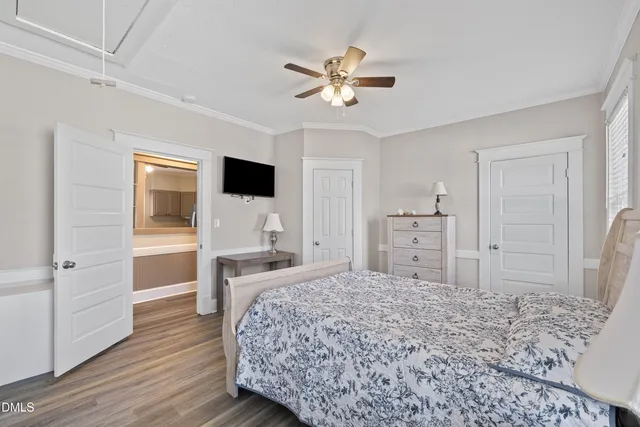 a bedroom with a large bed and a chandelier