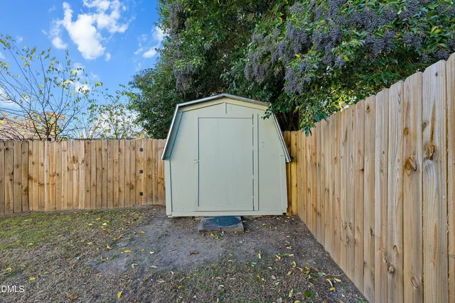 a view of a patio with a table and chairs