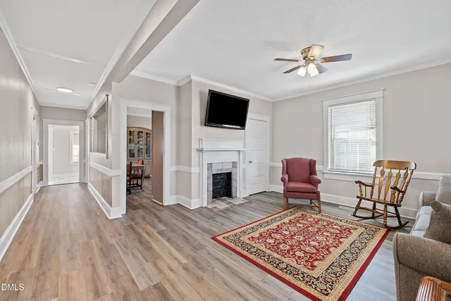 a living room with furniture rug and a fireplace