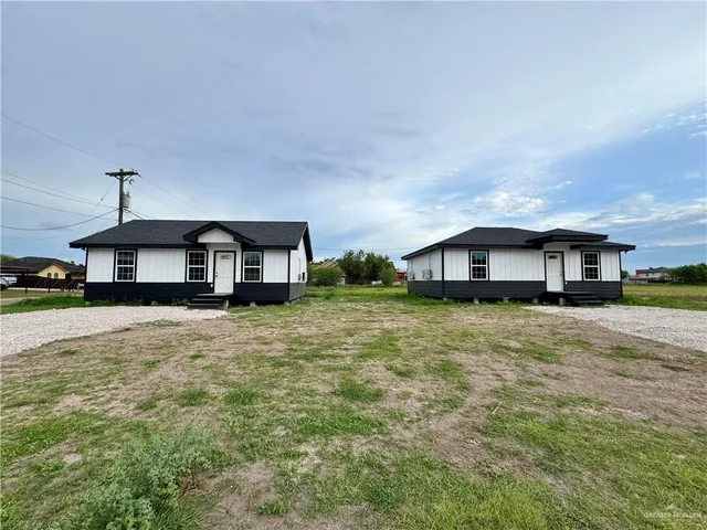 a front view of a house with a yard and balcony