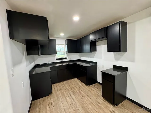 a kitchen with a sink and refrigerator