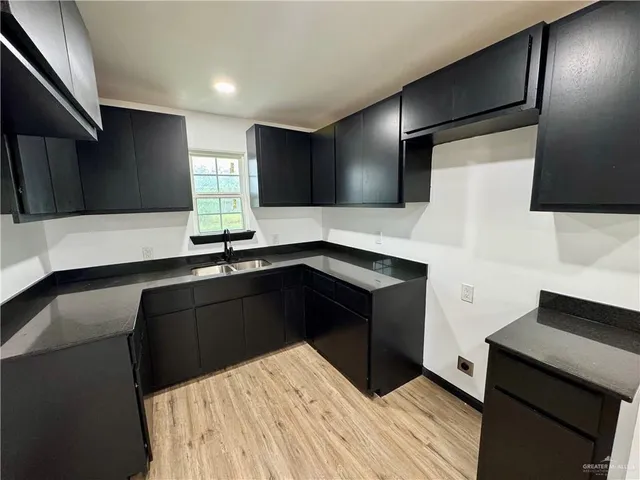 a kitchen with a sink and a refrigerator