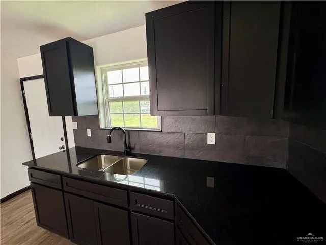 a kitchen with a sink a window and appliances