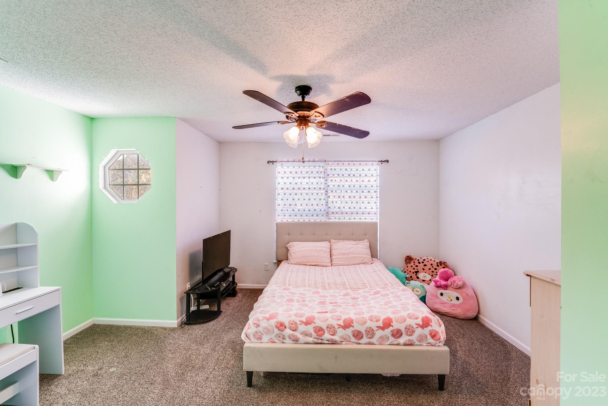 513 Red Oak Court Tega Cay, SC 29708 - Photo 14 of 21 a bedroom with a bed and a chandelier