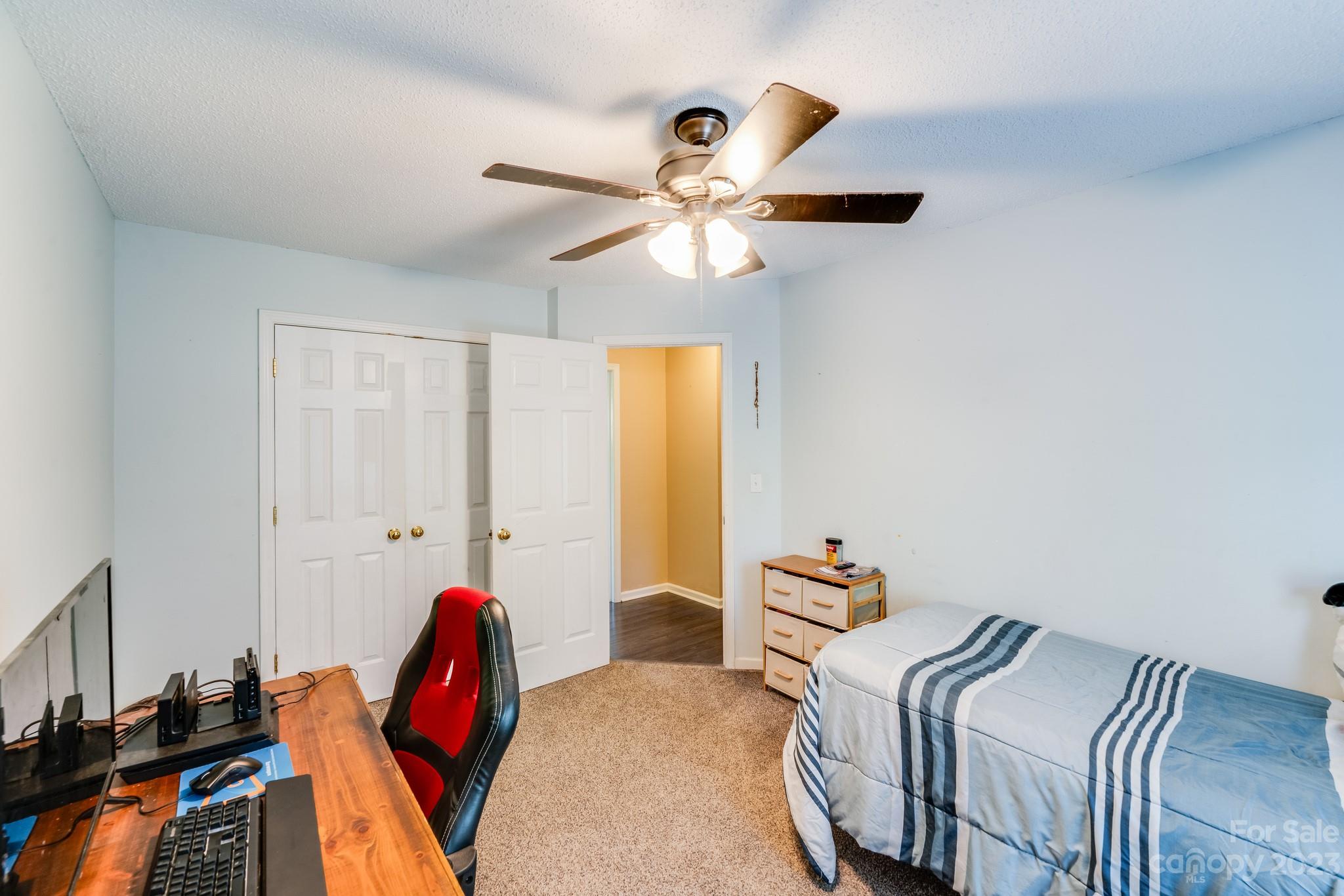 513 Red Oak Court Tega Cay, SC 29708 - Photo 15 of 21 a bedroom with bed and a chandelier