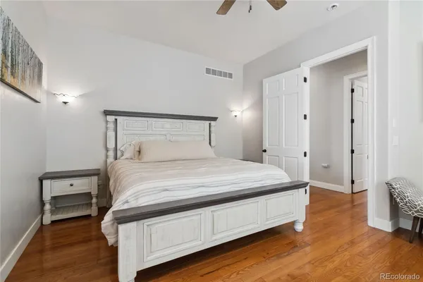 a bedroom with a bed and wooden floor