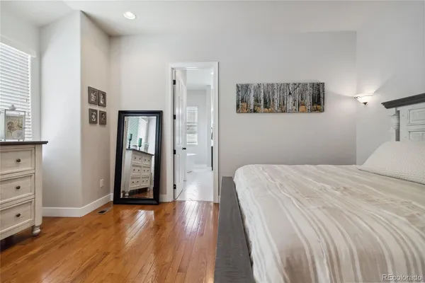 a bedroom with a bed and closet with mirror