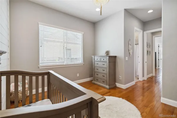 a view of a bedroom with furniture and window
