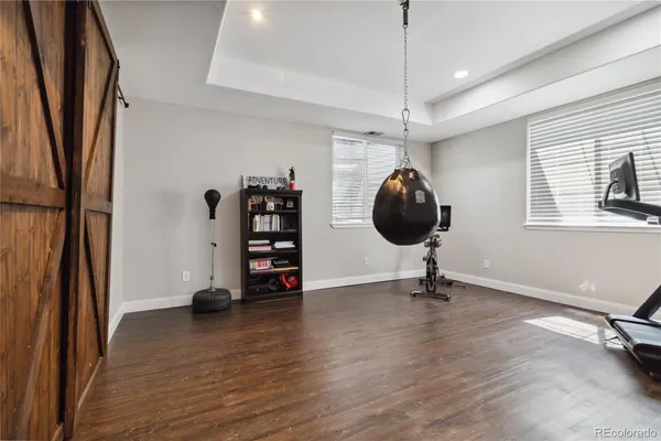 a view of a room with wooden floor staircase and a chandelier
