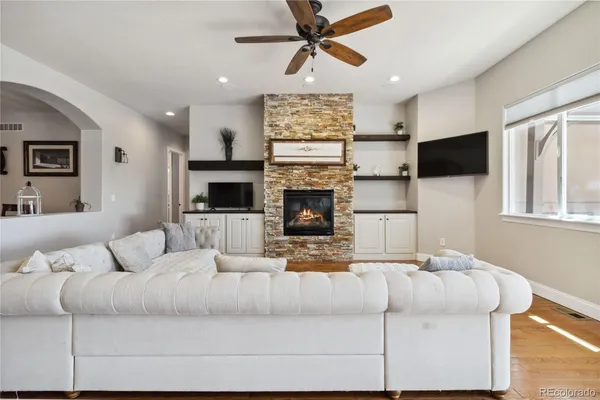 a living room with fireplace furniture and a flat screen tv
