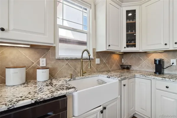 a kitchen with a sink and cabinets